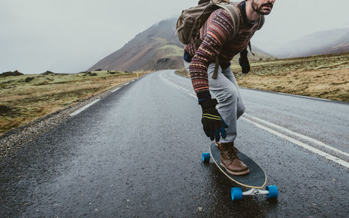 Man skateboarding on highway