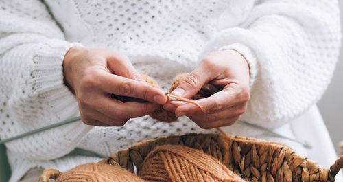 Midsection of woman holding rope