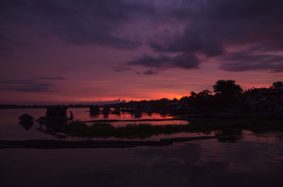 Scenic view of lake against orange sky