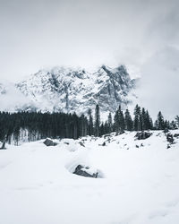 Scenic view of snow covered mountains against sky