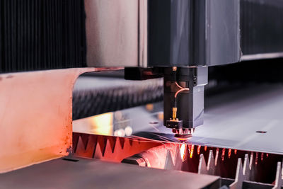 Scene close up, laser cutting machine cuts a metal plate. high-tech sheet metal production process