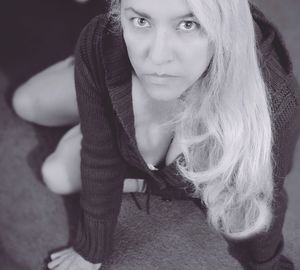 Portrait of young woman sitting at home