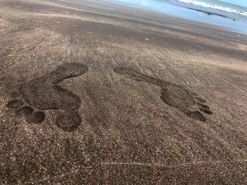 High angle view of footprints on beach