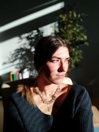 High angle view of sunlight falling on woman sitting at home