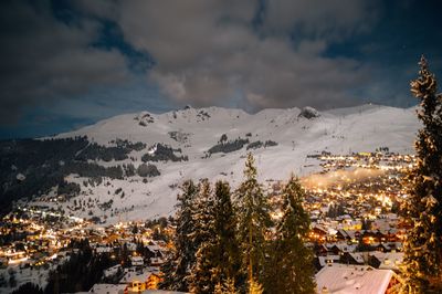 Aerial view of illuminated city against sky during winter