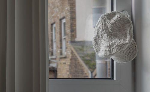 Rear view of woman looking through window