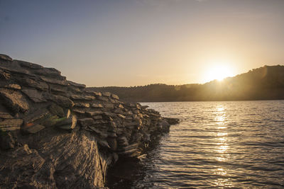 Scenic view of calm sea against sky during sunset