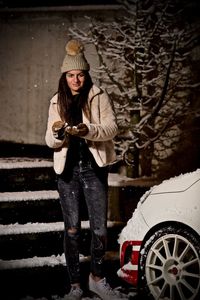 Full length of woman standing in snow