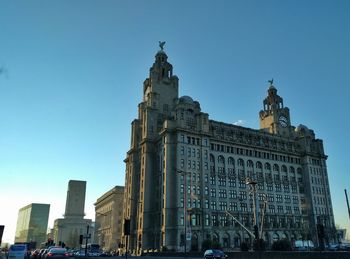 Low angle view of buildings against blue sky