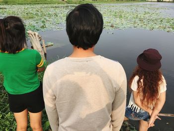 Rear view of women standing on grass