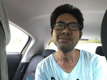 Portrait of young man in car