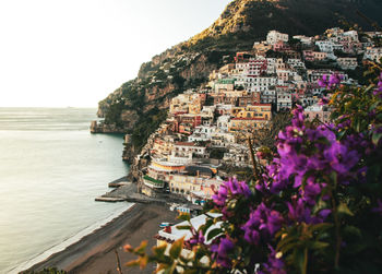 View of townscape by sea against clear sky