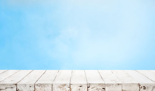 Low angle view of wall against blue sky