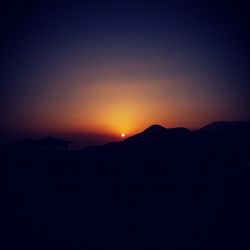 Scenic view of silhouette mountains against sky at sunset