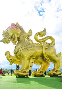 Low angle view of statue against cloudy sky