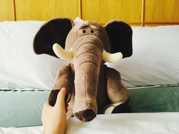 Close-up of stuffed elephant on bed at home