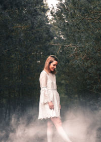 Young woman with white powder in forest