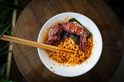 Korean hot spicy fried chicken served with ramen instant noodles, stir fried noodle.