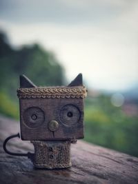 Close-up of figurine on table against sky