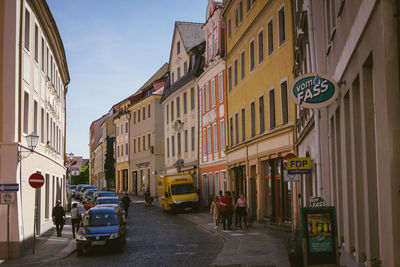 Cars on street amidst buildings in city