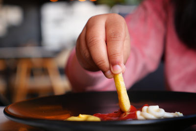 Cropped hand of person preparing food