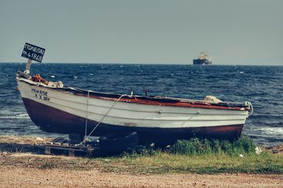 Ship moored on sea against sky