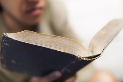 Midsection of man reading book