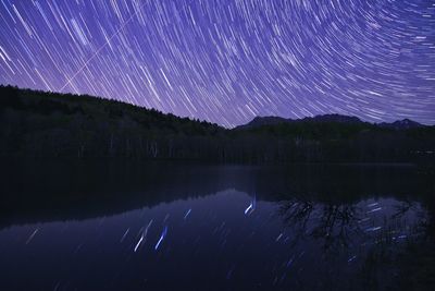 Scenic view of lake against sky at night