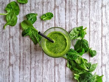 High angle view of healthy green smoothie against wooden background