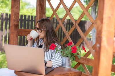 Woman holding coffee cup on table