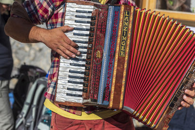 Midsection of man playing piano