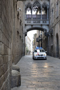 Cars on street amidst buildings in city