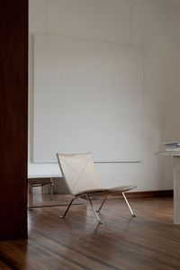 Table and chairs on floor against wall at home