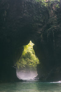 Scenic view of sea seen through cave
