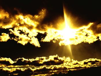 Low angle view of sun in sky during sunset