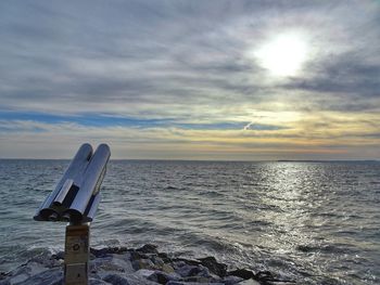 Scenic view of calm sea against cloudy sky