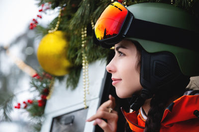 Portrait of a woman in the alps. young beautiful caucasian woman in ski goggles looking at the