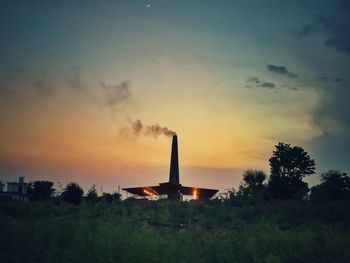 Silhouette built structure against sky during sunset