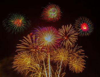 Low angle view of firework display at night