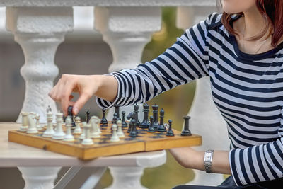 Young woman playing chess