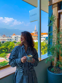 Young woman drinking coffee in city