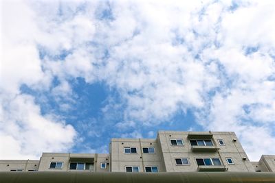 Low angle view of building against cloudy sky