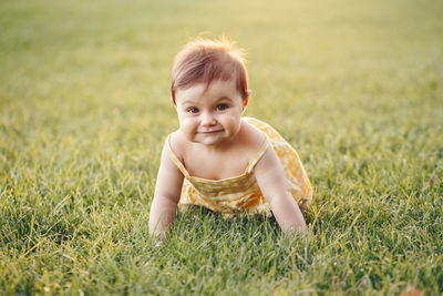Portrait of cute boy on grass