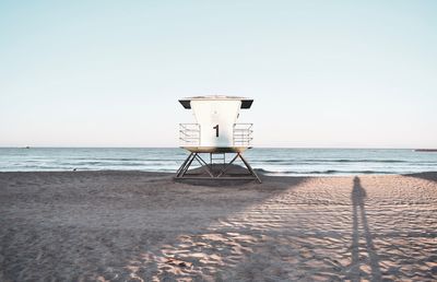 Lifeguard hut on beach against clear sky