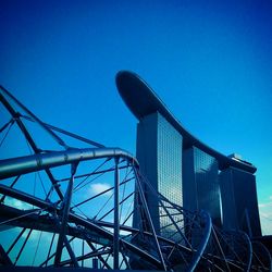 Low angle view of bridge against clear blue sky