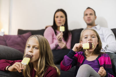 Family eating ice cream in living room