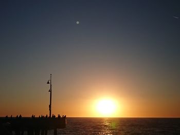 Scenic view of sea against orange sky