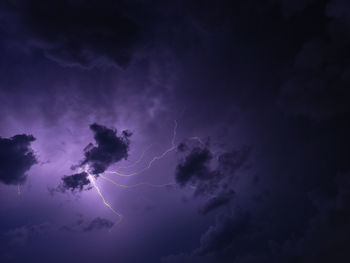 Low angle view of lightning against sky at night