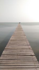 Pier over sea against clear sky