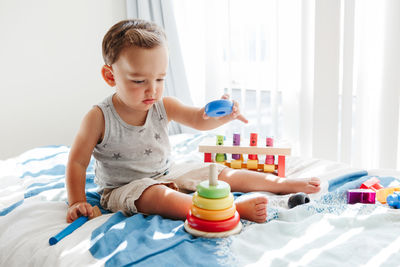 Boy playing with toy at home